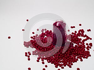 Red masterbatch granules isolated on a white background,This polymer is a coloring agent for products in the plastics industry