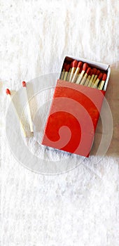Red match box with match sticks on an  white background