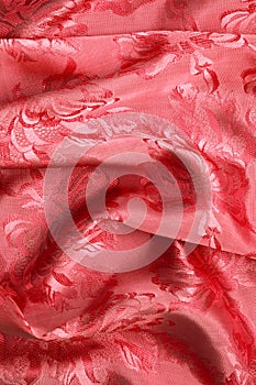 Red material waves with floral pattern