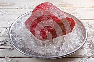 Red meat lying on ice.