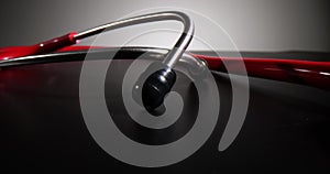 Red medical stethoscope on black background and health concept