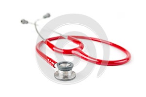 Red medical stetoskop isolated on a white background. Studio shot. Front View. Shallow depth of field. photo