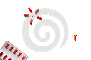 Red medicines on a white background - tablets in capsules, pills in packages