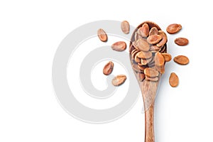 Red melon seed in a wooden spoon