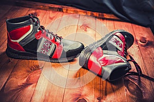 Red men's shoes on a wooden background