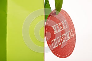 Red Merry Chritmas card on green paper bag