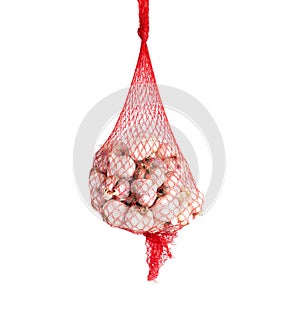 Red mesh garlic on a white background, isolate. Close-up, white-skinned garlic