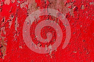 Red metal background with peeling blistering paint photo