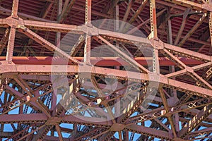 Red metal beam structure of Golden Gate Bridge in San Francisco, California