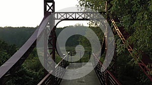 The red metal bridge over a small river