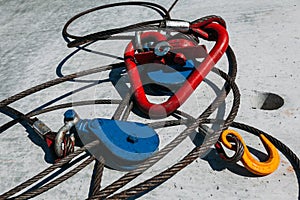 Red metal cable holder in the form of a heart on a concrete background