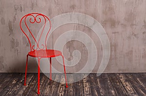 Red metal chair in nterior room