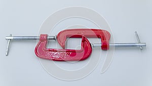 red metal clamp, press for locksmith work.red G-clamps
