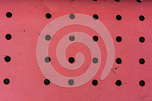 Red metal construction with holes dotted top view looking down abstract view design retro pattern