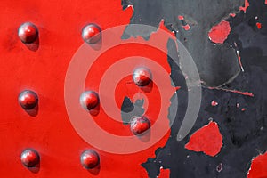 Red metal plate background - riveted industrial steel