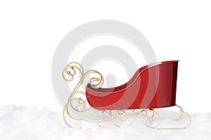 Red metal santa sleigh on snow