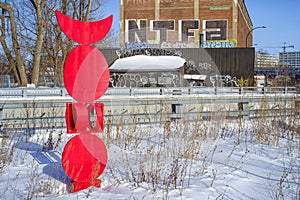 Red metal Sculpture in Faubourg park beside the St-Lawrence wharehouse