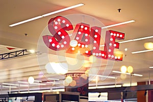 Red metal signage shop lighting on shopping mall background