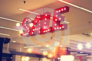 Red metal signage shop lighting on shopping mall background