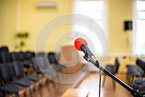 Red microphone in an empty room, the concept of emptiness and despair in human life, emptiness and the abyss in the soul of a lone photo