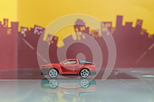Red mini truck or pick up car toy selective focus on blur city background