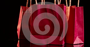 red miniature shopping bags rotating