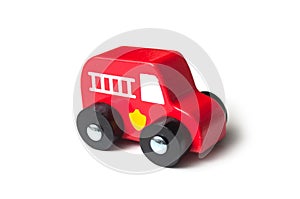 Red miniature wooden truck on white background - concept fire rescue