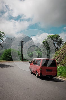 Red minibus through Green plains and mountains with view over the city of Assomada on the island of Santiago, Cabo Verde islands photo