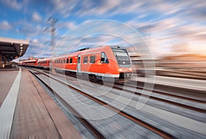 Red modern high speed train in motion