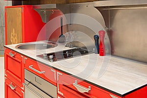 Red modern kitchen room interior with furniture and counter for concept design - light home background