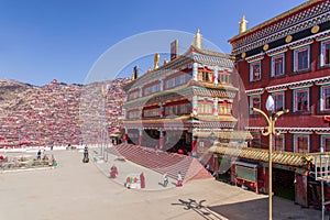 Red monastery and home at Larung gar Buddhist Academy in sunshine day and background is blue sky, Sichuan, China