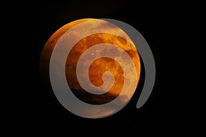 Red moon eclipse eclipsed by Earth and clouds