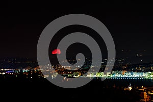 Red moon over the promenade des Anglais in Nice, France at night