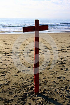 Red mooring pole in the shape of a cross, in sunset light