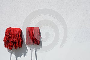 Red mop and white background wall