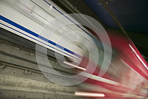 Red motion blur of speeding train at Metro subway train station in Madrid, Spain