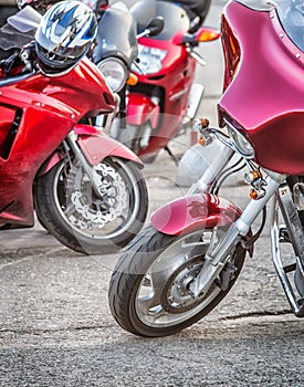 Red motorcycles are parked in the city