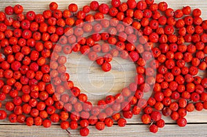 Red mountain ash in a wooden support and heart from mountain ash berries