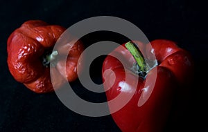 Red moyldy pepper on a black background