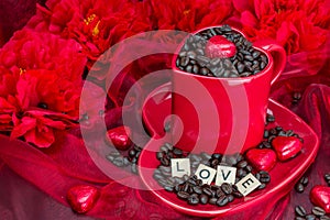 Red mug with LOVE letters rosted coffee beans sexy red background photo