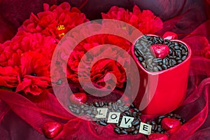 Red mug rosted coffee beans with heart chocolates red flowers Love letter photo