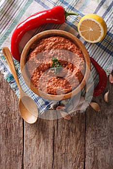 Red Muhammara and ingredients. Vertical top view