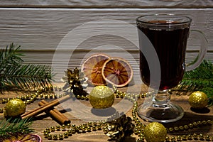 Red muled wine with sicilian citrus and sparkling golden Christmas balls and beads.