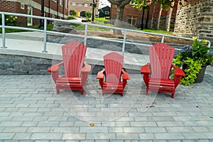 3 red Muskoka chairs on the street in Cottage Country, Ontario photo