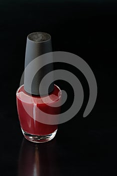 Red nail polish in a bottle
