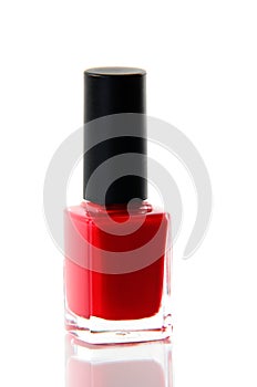 Red nail polish bottle over white