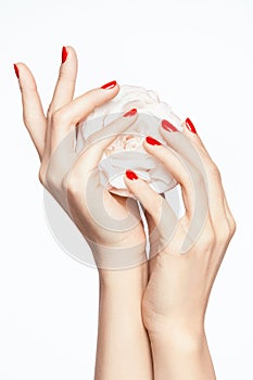 Red Nails. Woman Hands With Flower And Red Manicure