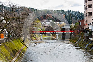 Red Nakabashi bridge the entrance to historic old town, a tourist destination in the mountain city of Hida-Takayama in Gifu, Japan