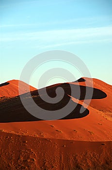 Red namib dune under lightblue sky