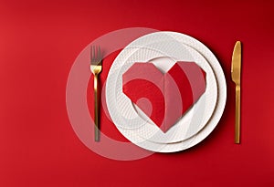 Red napkin heart on white plates